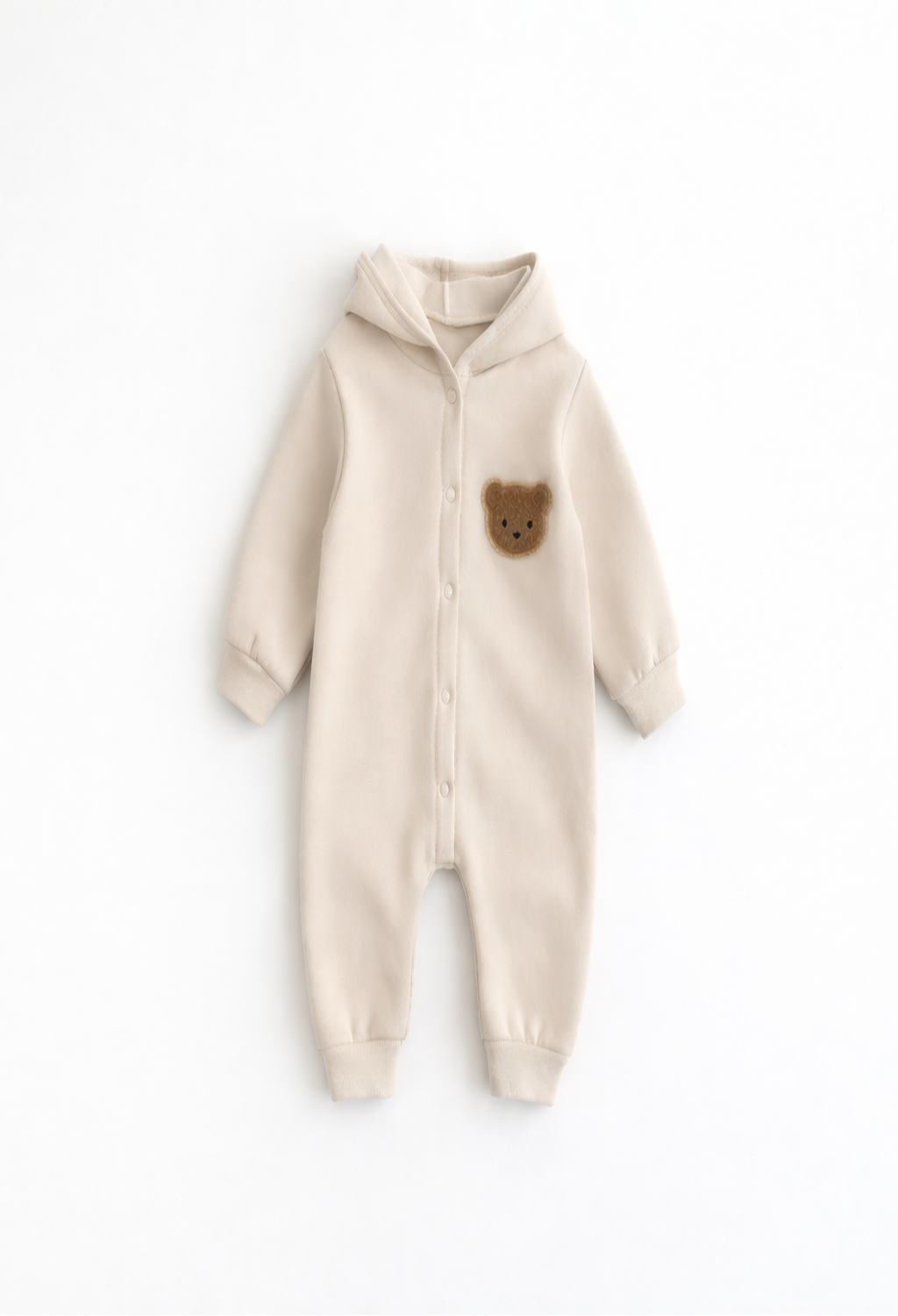 Beige baby onesie with a bear patch on a white background