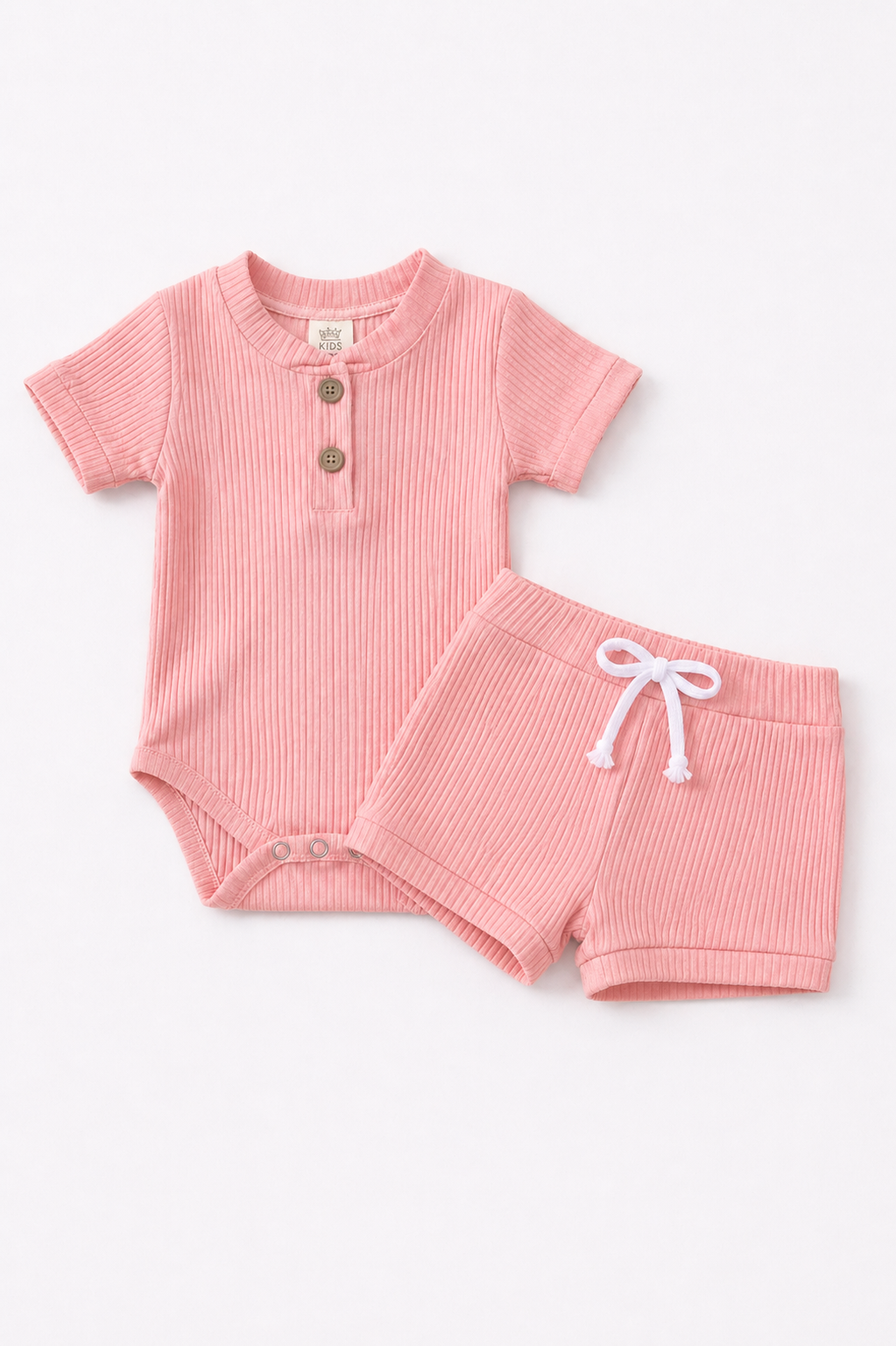 Pink baby outfit with short-sleeve top and shorts on a white background