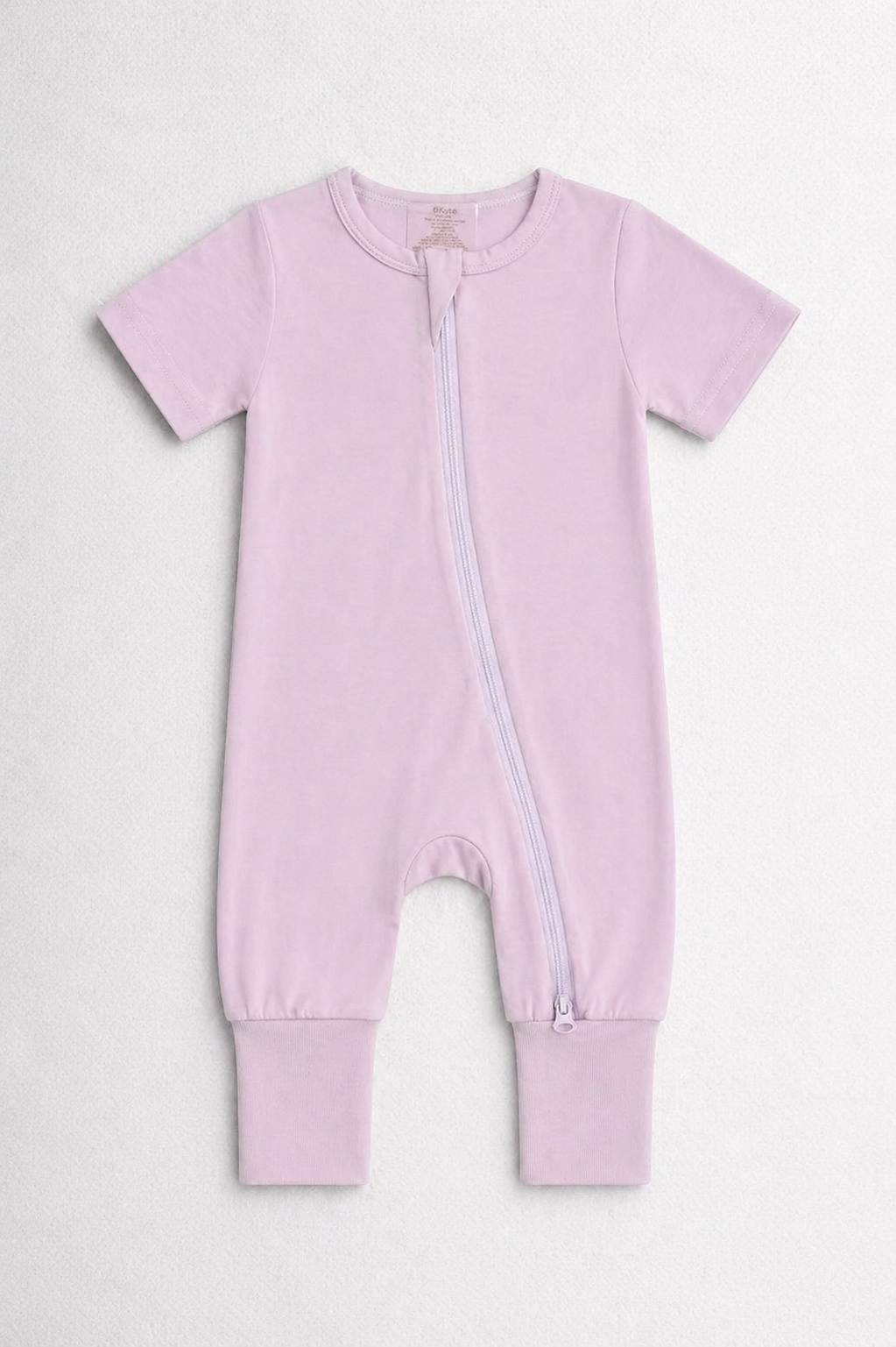Light pink baby onesie with a zipper on a white background