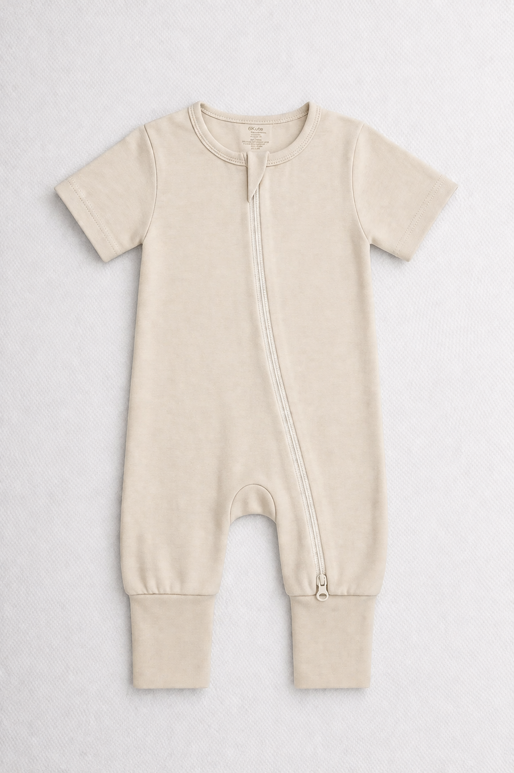 Beige baby onesie with a zipper on a white background