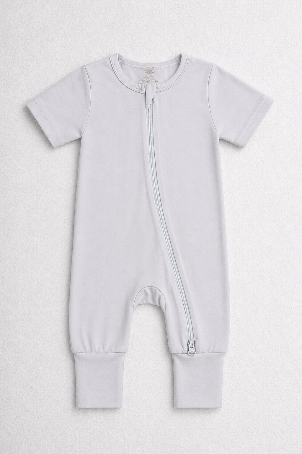 Light grey baby onesie with a zipper on a white background
