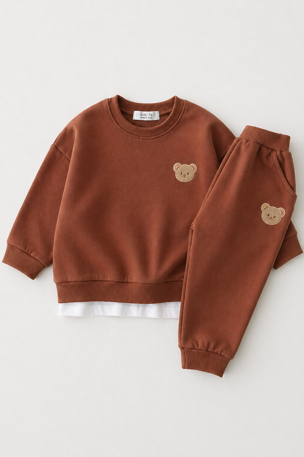 Brown children's sweatshirt and pants set with bear face designs on a white background