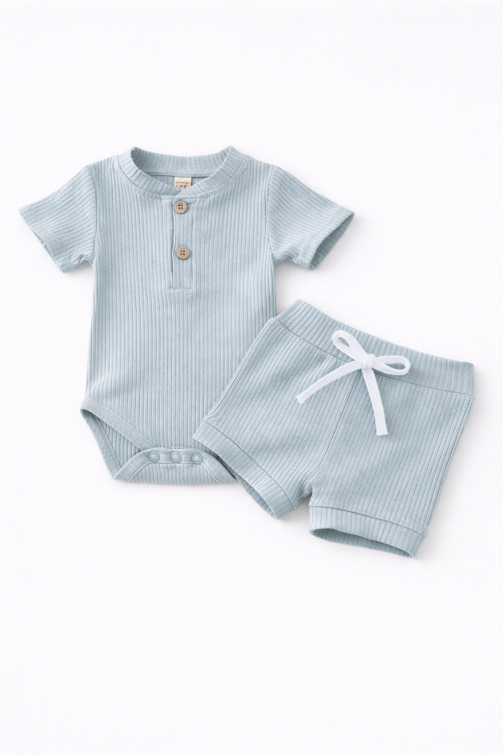 Light blue baby outfit with romper and shorts on a white background