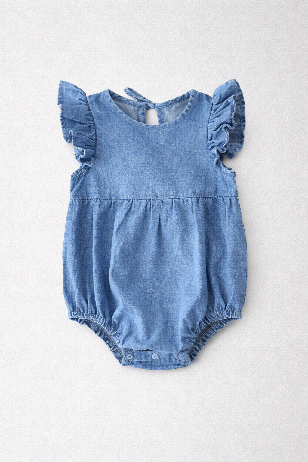 Blue baby girls romper with ruffled sleeves on a white background