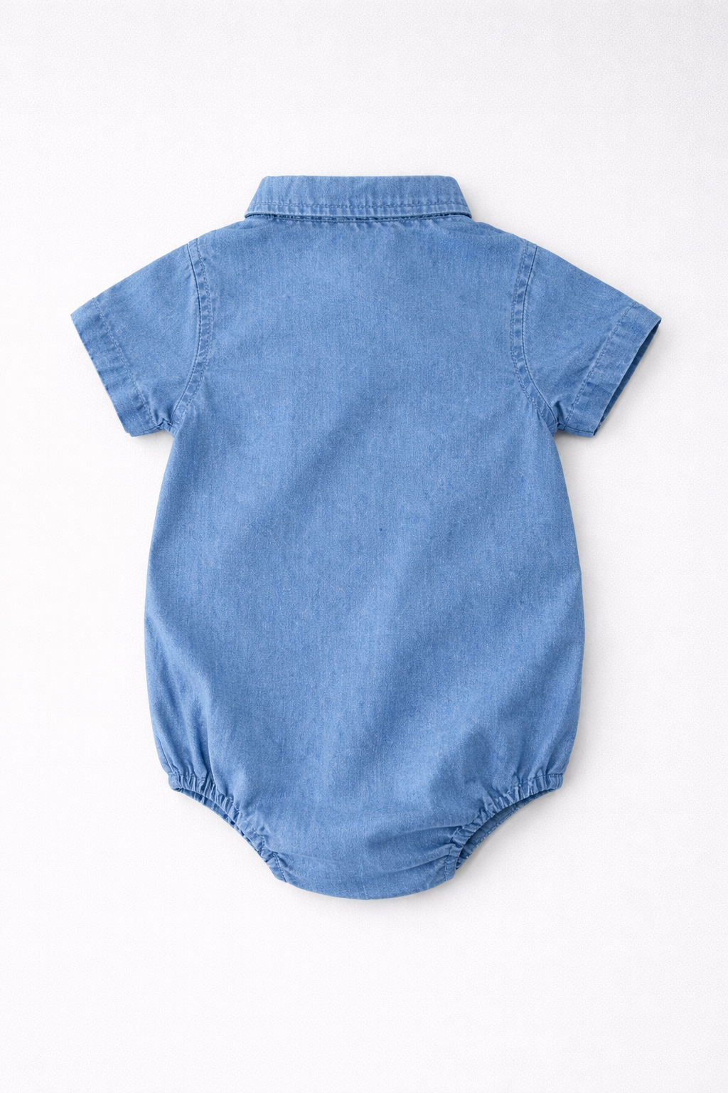 Boys blue denim baby romper with collar and button details on a light grey background