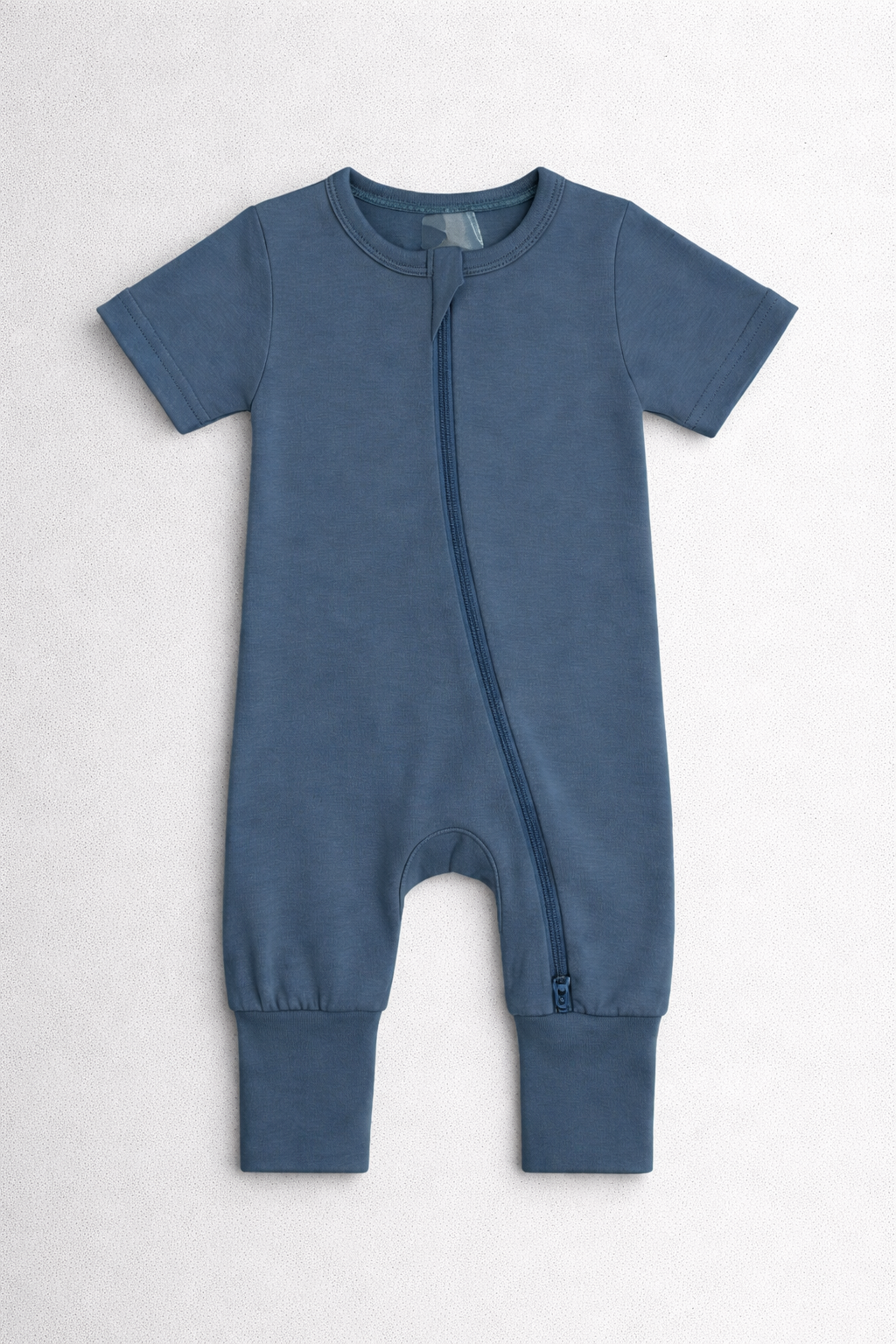 Navy blue baby onesie with a zipper on a white background