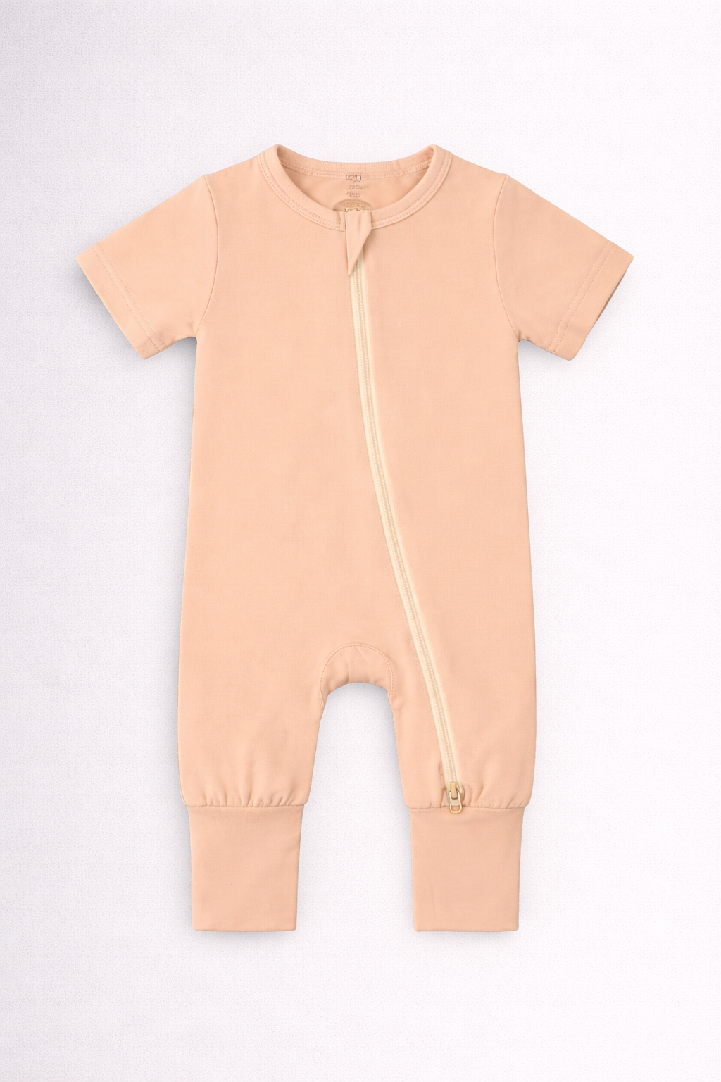 Apricot baby onesie with a zipper on a white background
