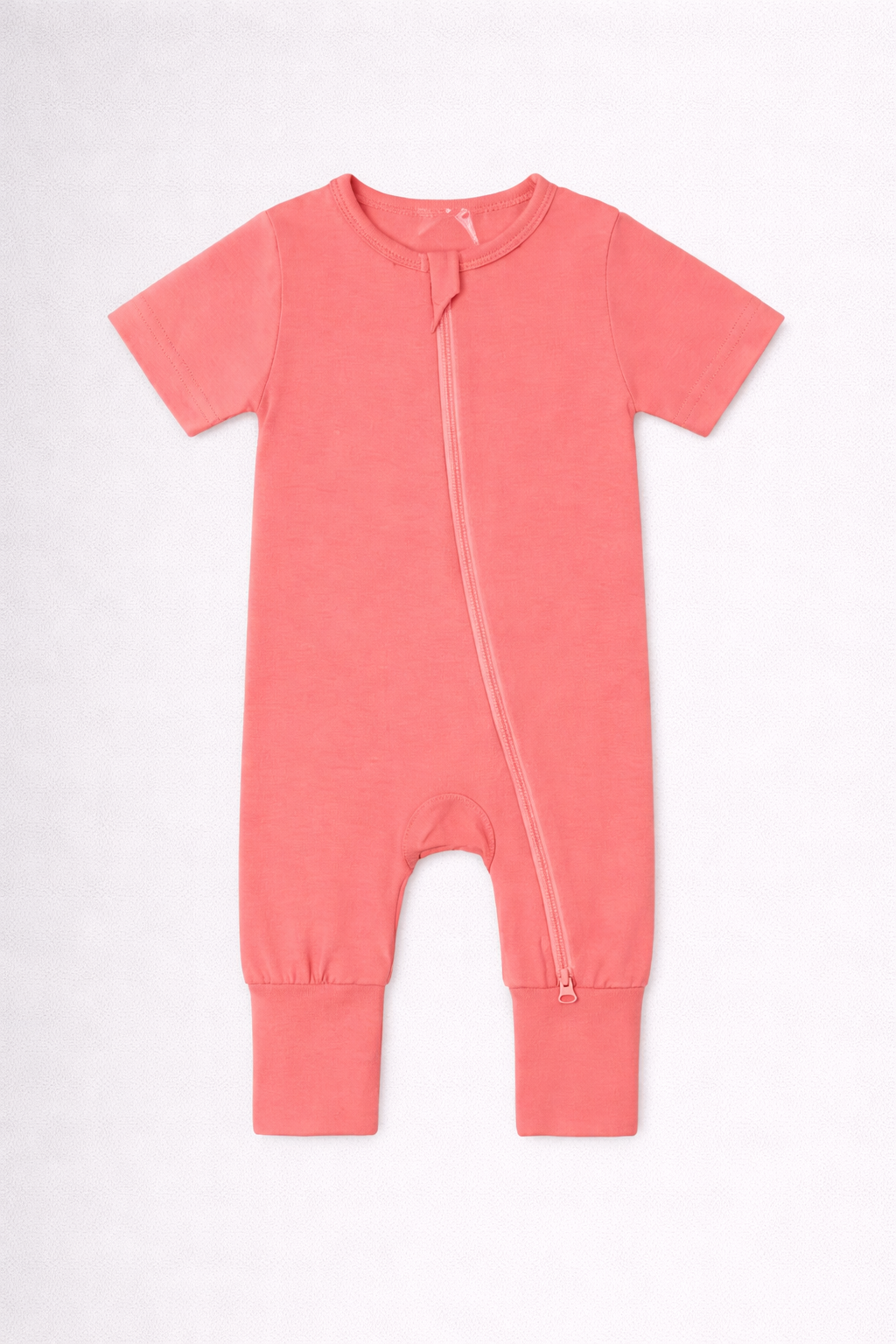 Coral pink baby onesie with a zipper on a white background