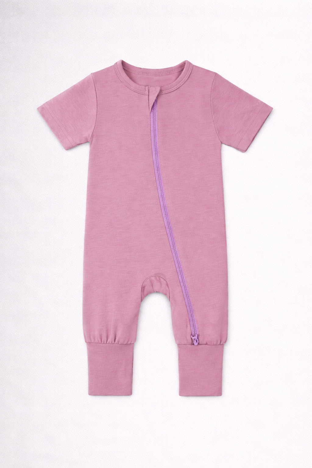 Mauve pink baby onesie with a purple zipper on a white background