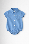 Boys blue denim baby romper with collar and button details on a light grey background