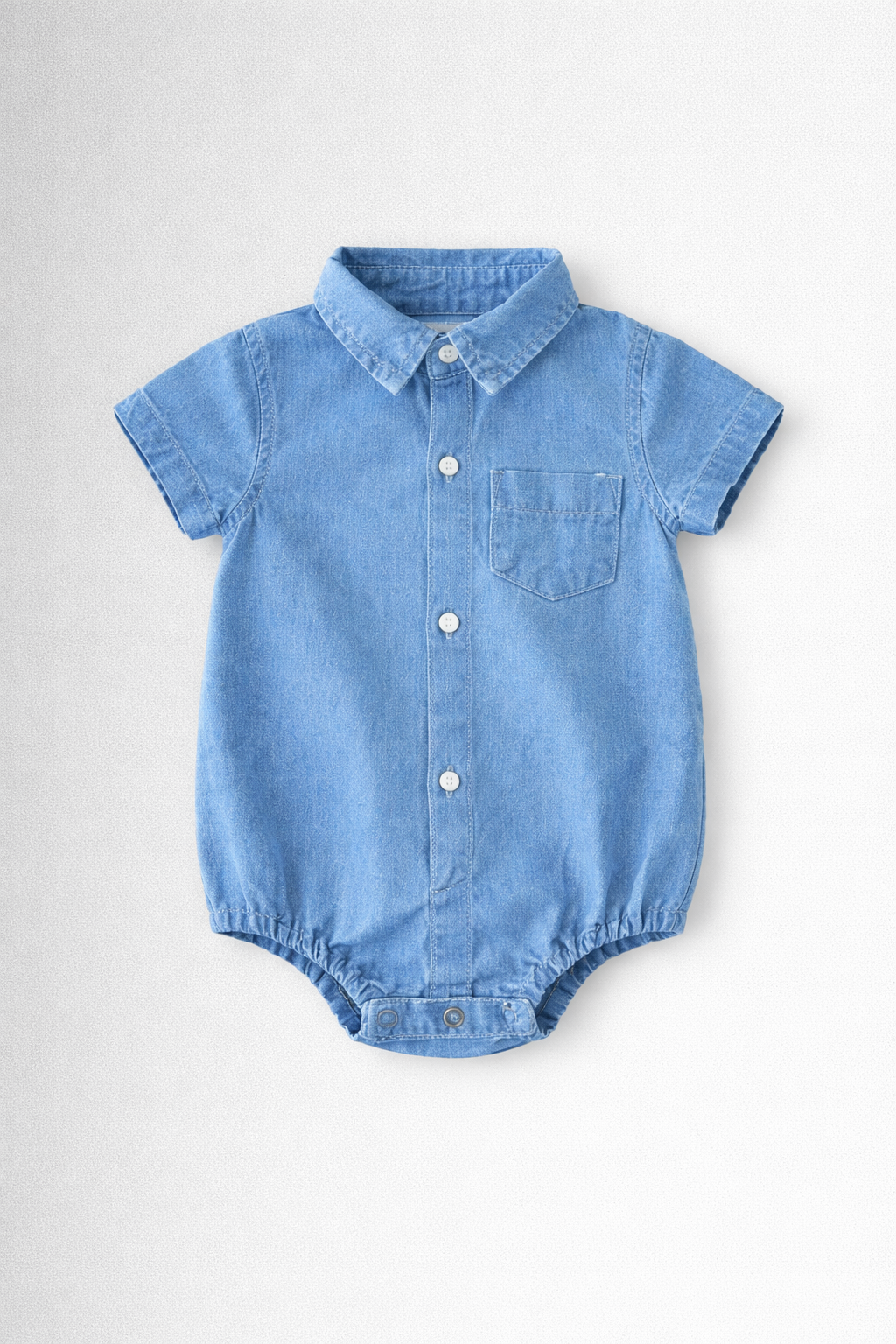 Boys blue denim baby romper with collar and button details on a light grey background