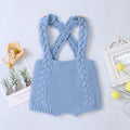 Light blue knitted baby romper with braided straps on a light gray background