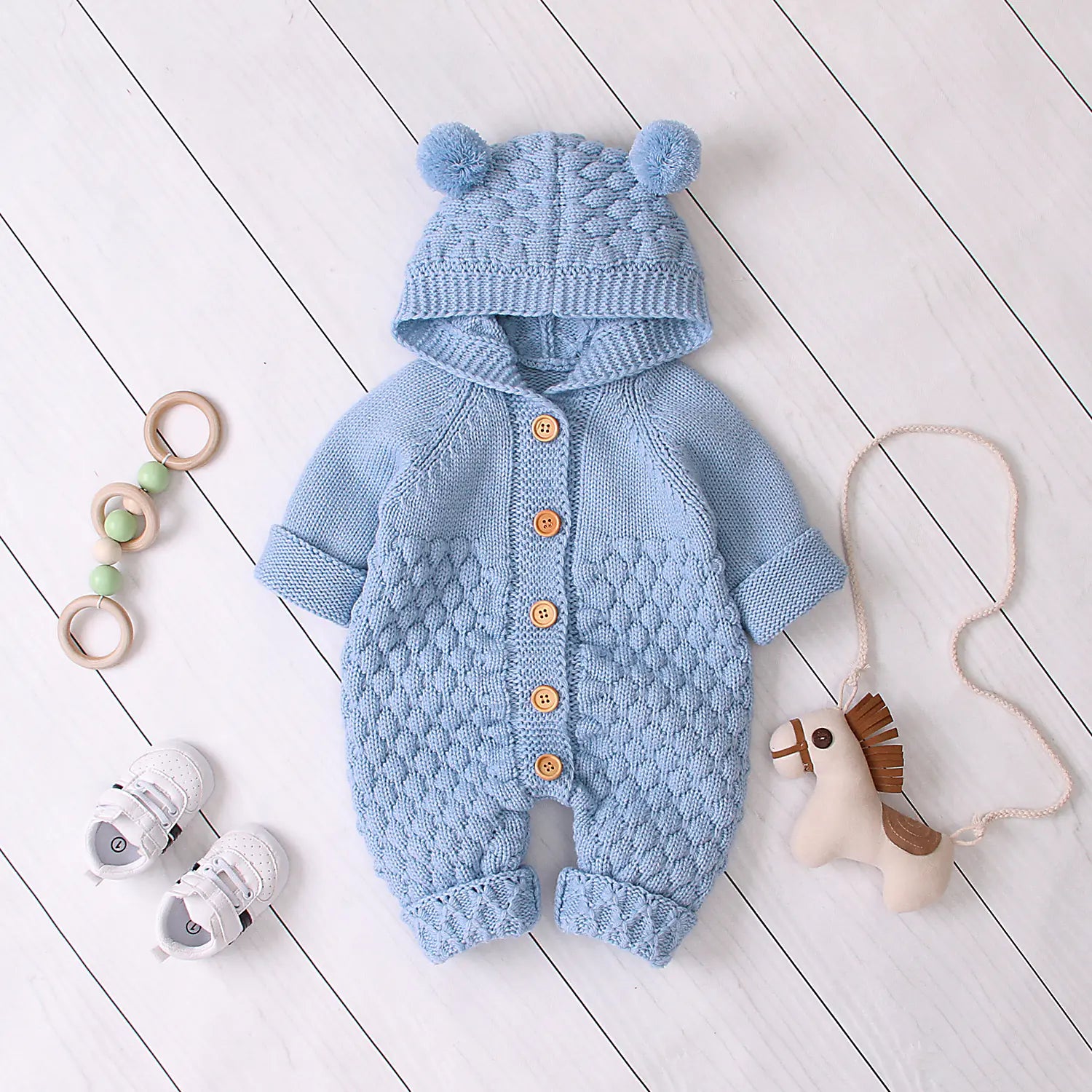Light blue knitted hooded jumpsuit with toys